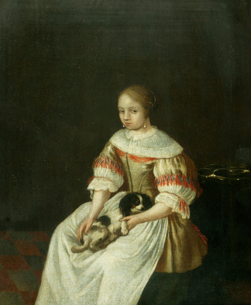 A lady seated holding a small dog