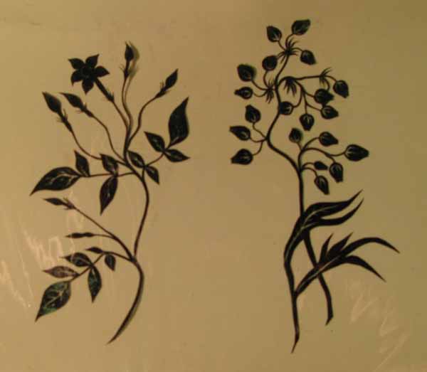 Two Black Paper Silhouettes of Flowers with Stems and Leaves.